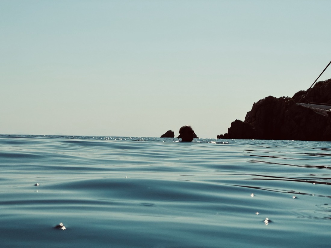 Turquoise sea meeting a rocky headland at the horizon