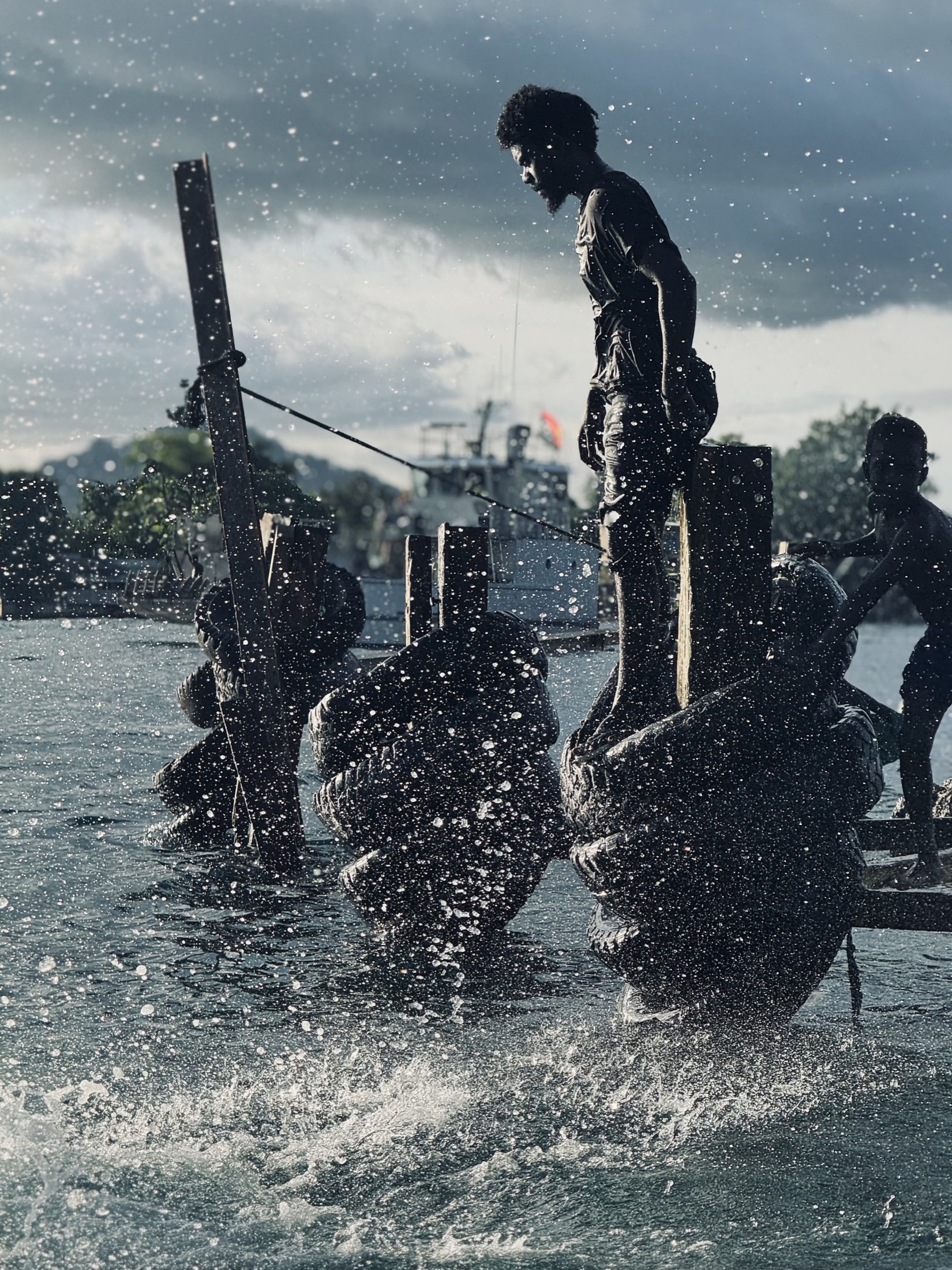 Figures silhouetted against bright water from the deck of a boat