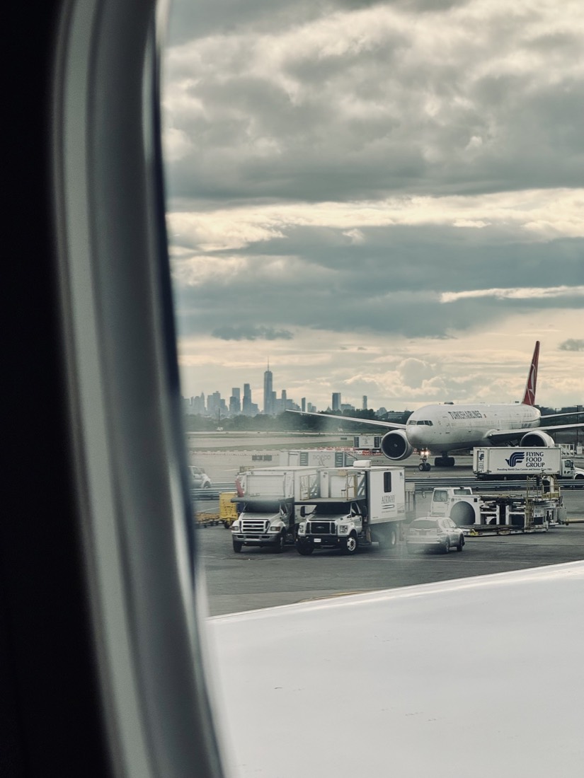 Airport apron and terminal seen through an aeroplane window