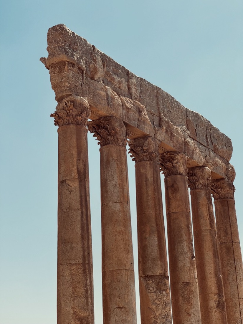 Ancient Roman temple columns against a blue sky