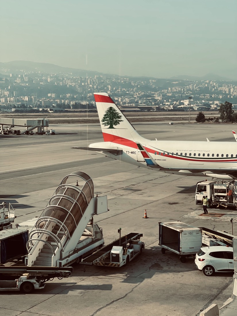 Airliner at the gate with baggage stairs on the apron
