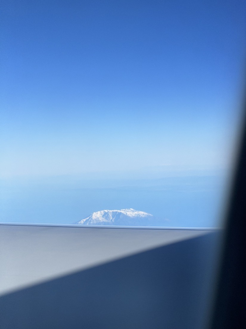 Clear blue sky and wing seen from an aeroplane window