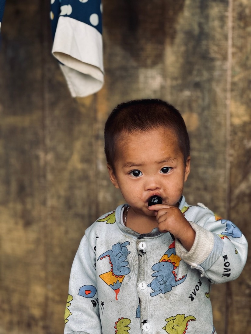 Toddler in patterned clothes looking into the camera